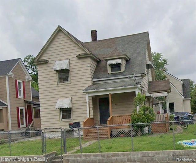 view of front of house featuring covered porch and a front yard