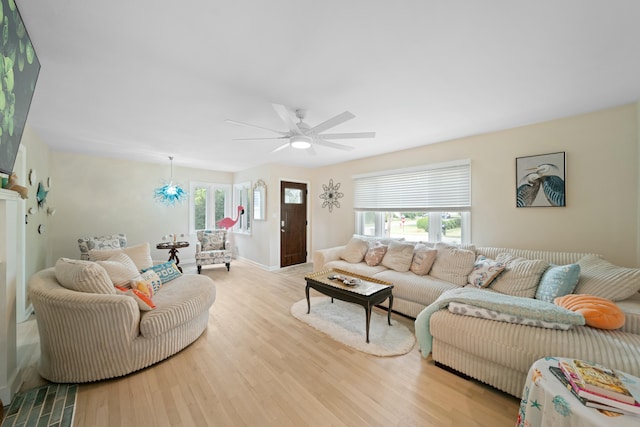 living room featuring ceiling fan and light wood-type flooring