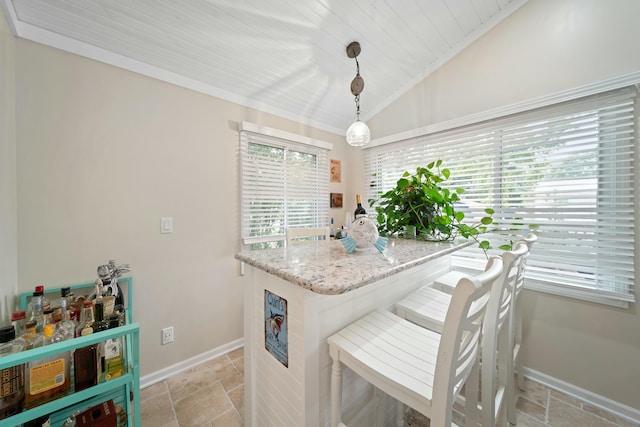 kitchen featuring lofted ceiling, light stone counters, wood ceiling, hanging light fixtures, and a kitchen breakfast bar