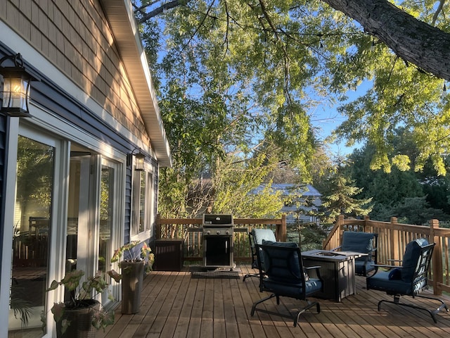 wooden terrace featuring a grill