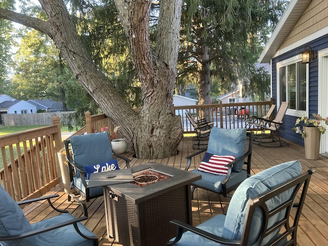 wooden deck featuring an outdoor fire pit