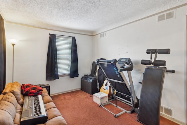 exercise room with carpet flooring, a textured ceiling, and ornamental molding