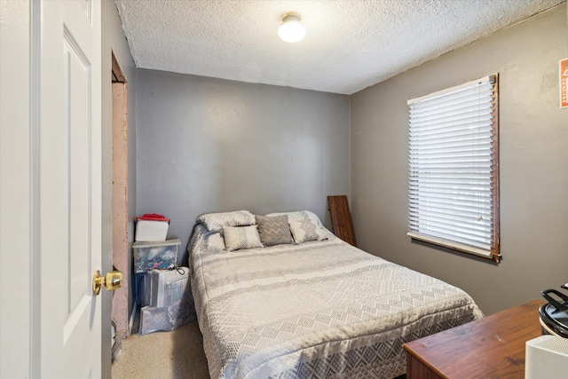 bedroom with a textured ceiling and carpet floors