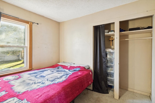 carpeted bedroom featuring a textured ceiling