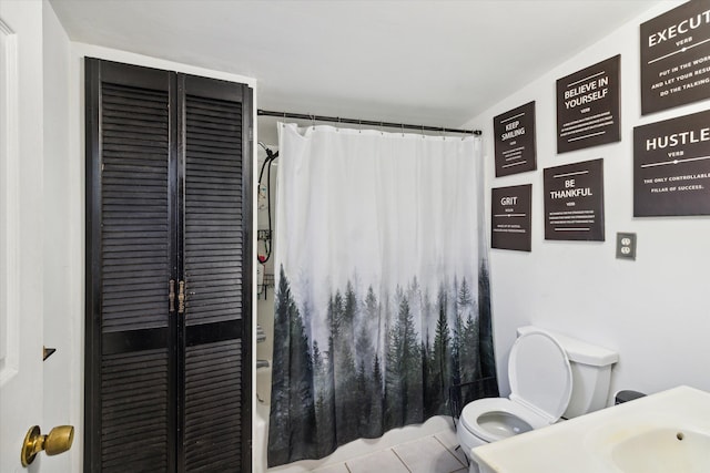 full bathroom with tile patterned floors, vanity, toilet, and shower / bath combination with curtain