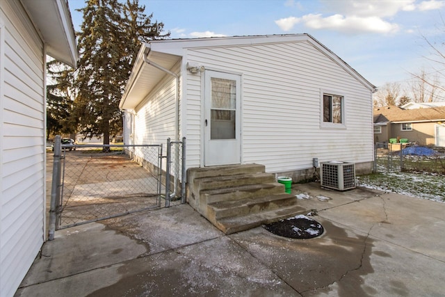 back of property with central AC and a patio area