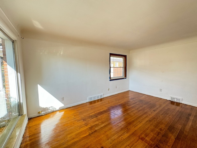 empty room with hardwood / wood-style flooring