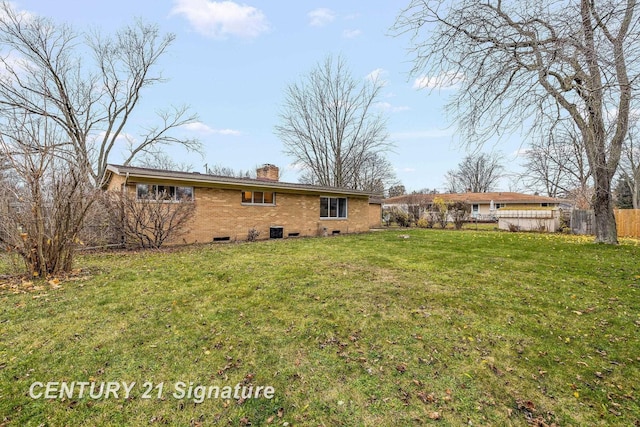 rear view of property featuring a yard