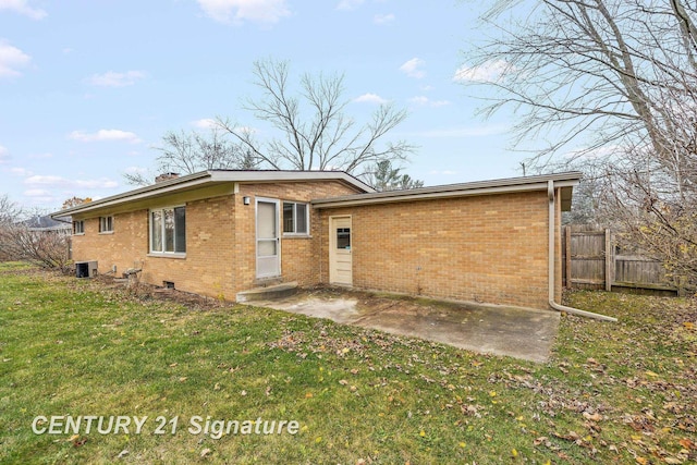 rear view of property featuring central AC, a patio area, and a yard