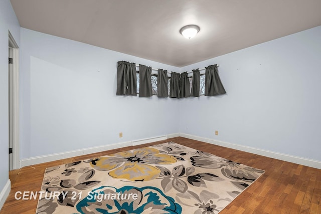 unfurnished room with wood-type flooring