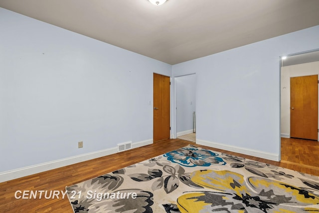 unfurnished room featuring wood-type flooring