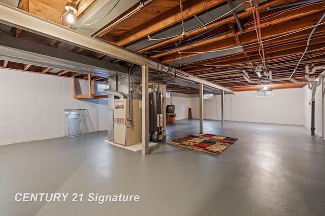 basement featuring gas water heater and heating unit