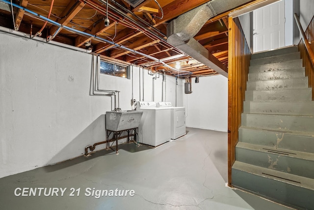 basement featuring washer and clothes dryer and sink