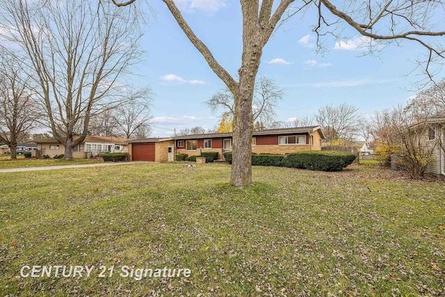 ranch-style house with a garage and a front yard