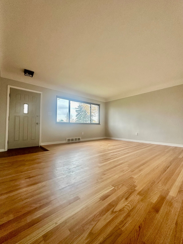 interior space with light hardwood / wood-style floors and a textured ceiling