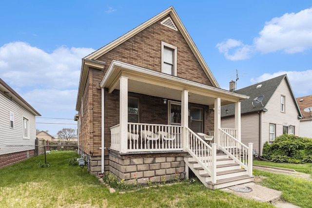 view of front of home featuring a porch and brick siding