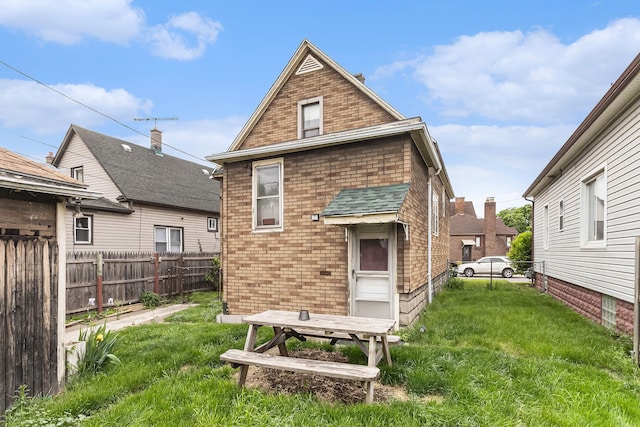 rear view of property featuring brick siding