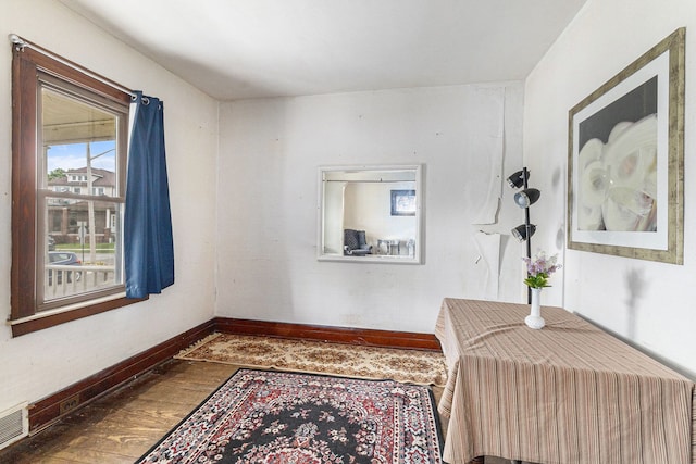 bedroom featuring wood finished floors and baseboards