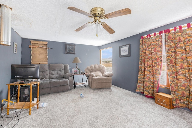 carpeted living room with ceiling fan and a textured ceiling