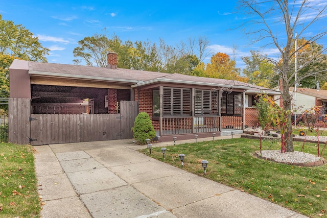 ranch-style home with a carport, a porch, and a front yard