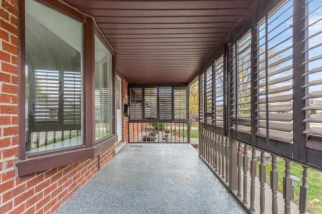 unfurnished sunroom with wood ceiling