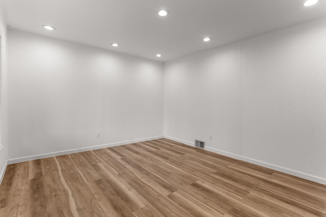 unfurnished room with hardwood / wood-style flooring