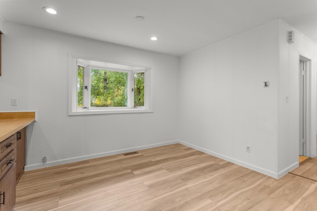 spare room featuring light hardwood / wood-style flooring