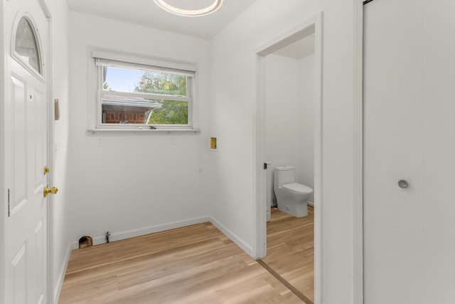 laundry area featuring light wood-type flooring