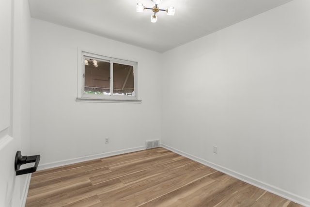 unfurnished room featuring hardwood / wood-style flooring