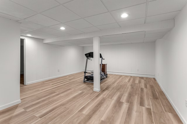 basement with light hardwood / wood-style floors and a drop ceiling