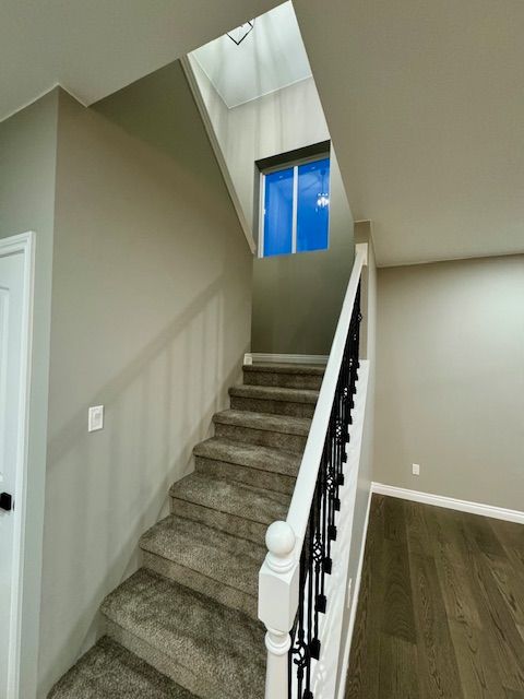 stairs featuring wood-type flooring