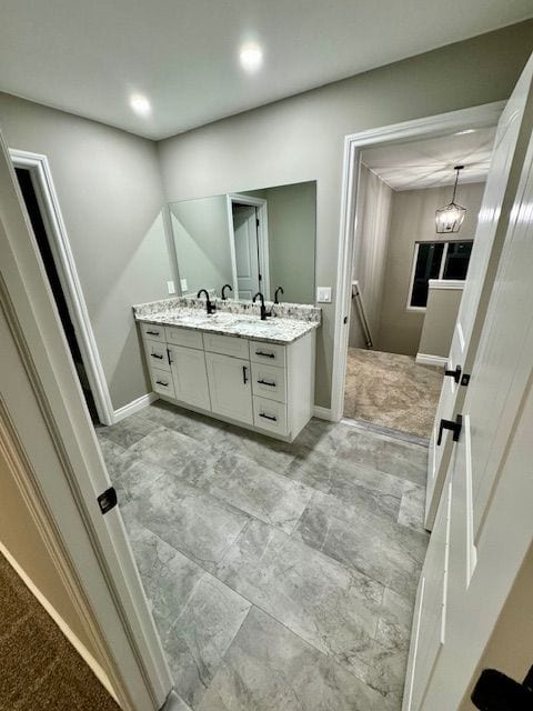 bathroom with vanity and a chandelier