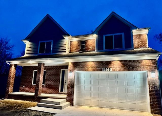 view of front of home featuring a porch and a garage