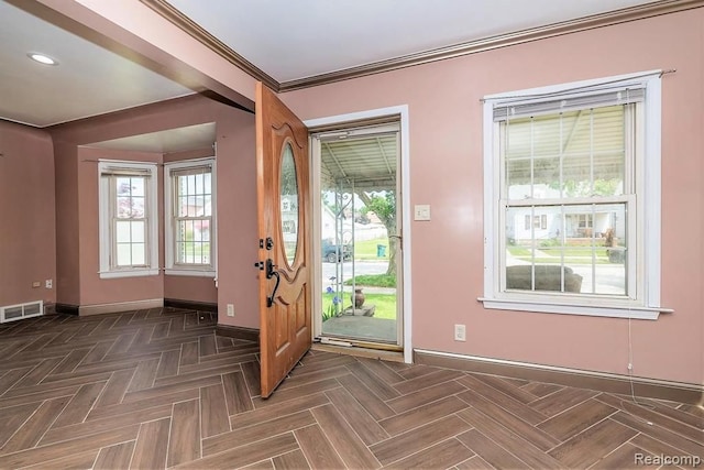 foyer featuring dark parquet floors and ornamental molding