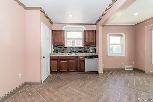 kitchen featuring dishwasher, parquet flooring, sink, and a wealth of natural light