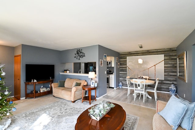 living room with wood walls and hardwood / wood-style floors