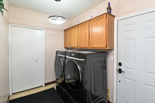 washroom featuring cabinets, separate washer and dryer, and light tile patterned floors