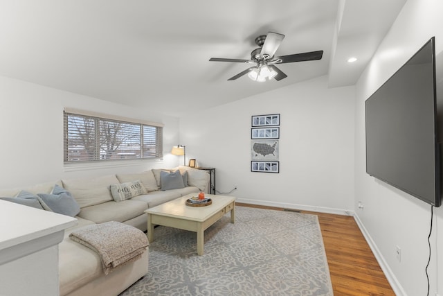 living room featuring hardwood / wood-style flooring, ceiling fan, and lofted ceiling