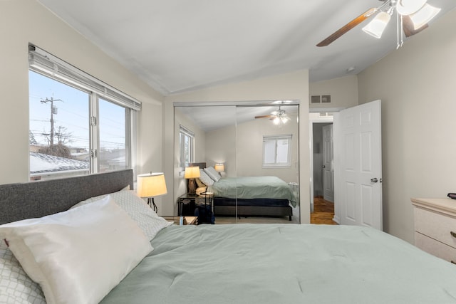 bedroom featuring ceiling fan, a closet, and lofted ceiling