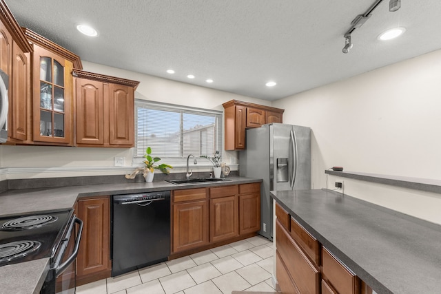 kitchen with sink, track lighting, black appliances, and a textured ceiling