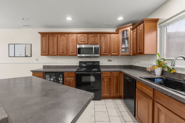 kitchen with black appliances, light tile patterned floors, sink, and beverage cooler