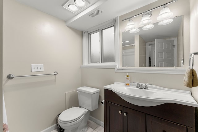 bathroom featuring tile patterned floors, vanity, and toilet