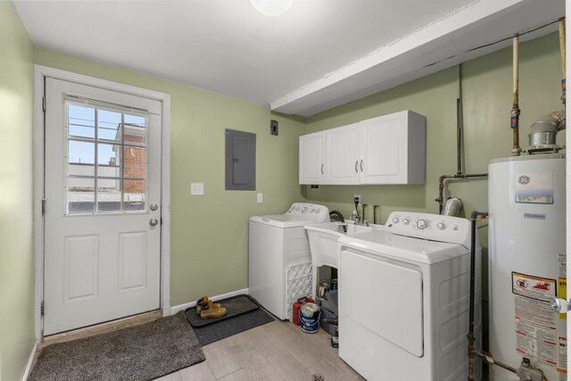 laundry area featuring cabinets, electric panel, gas water heater, light hardwood / wood-style floors, and washing machine and clothes dryer