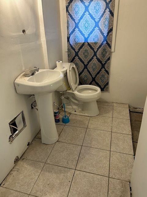 bathroom with tile patterned floors and toilet