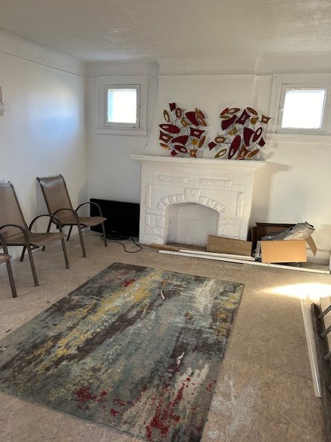 living room featuring a fireplace and a wealth of natural light