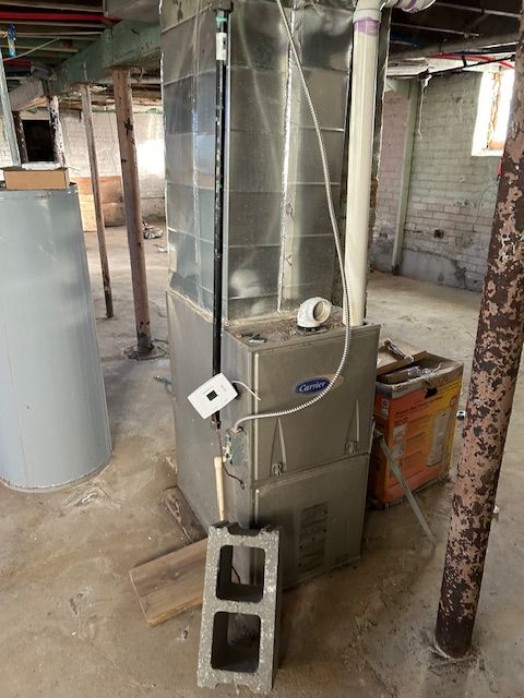 utility room featuring gas water heater and heating unit