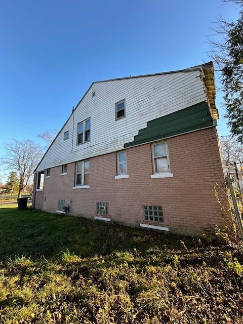 rear view of property with a lawn