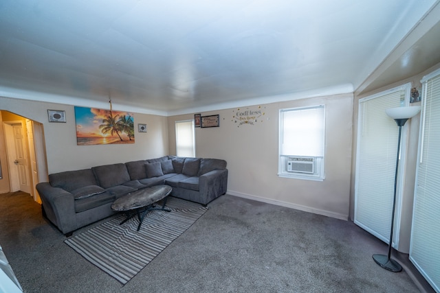 living room featuring cooling unit, carpet floors, and a wealth of natural light