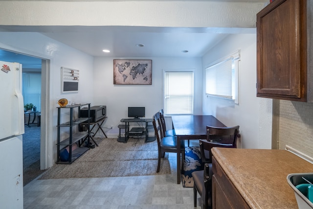 dining room with light colored carpet