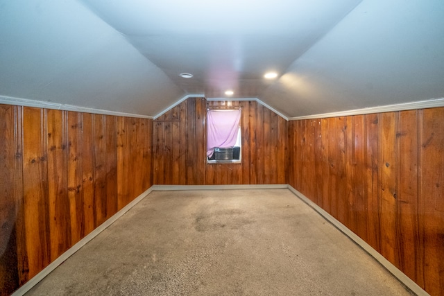 additional living space featuring carpet flooring, wood walls, and lofted ceiling